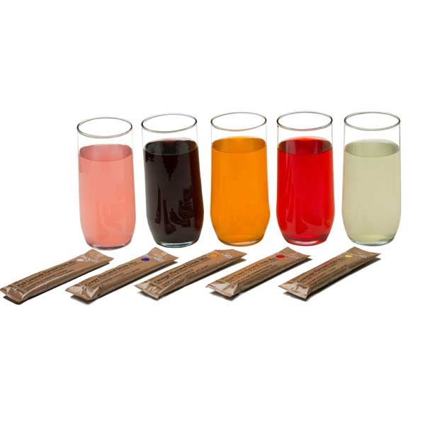Five glasses with different colored liquids and five wooden sticks on a white background
