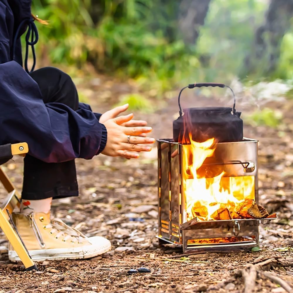 Person sitting by a campfire with a metal cooking pot and kettle, surrounded by nature.